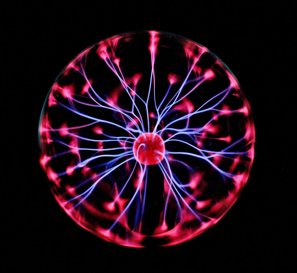 pexels-photo-414860-414860 Close-up of a plasma globe with vibrant neon sparks against a dark background.